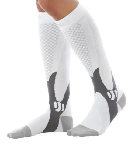 Graduated compression socks for men and women in black, shown laid flat.