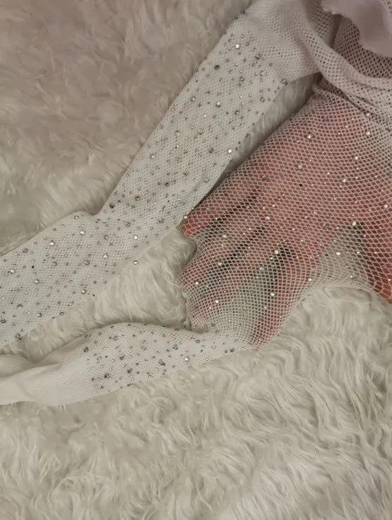 A pair of thin mesh fishnet stockings for women in solid skin colour, laid flat.