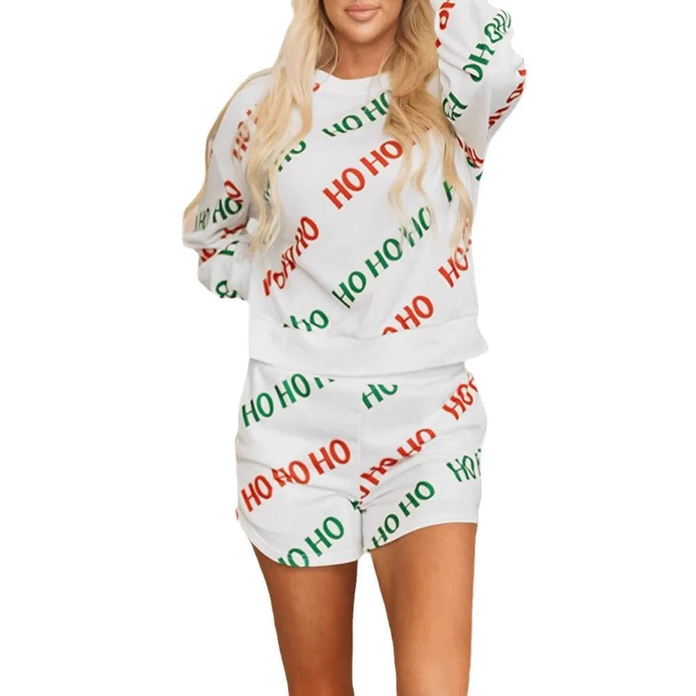 Women's white two-piece suit with printed letter pattern showing long sleeves and fifth-length trousers