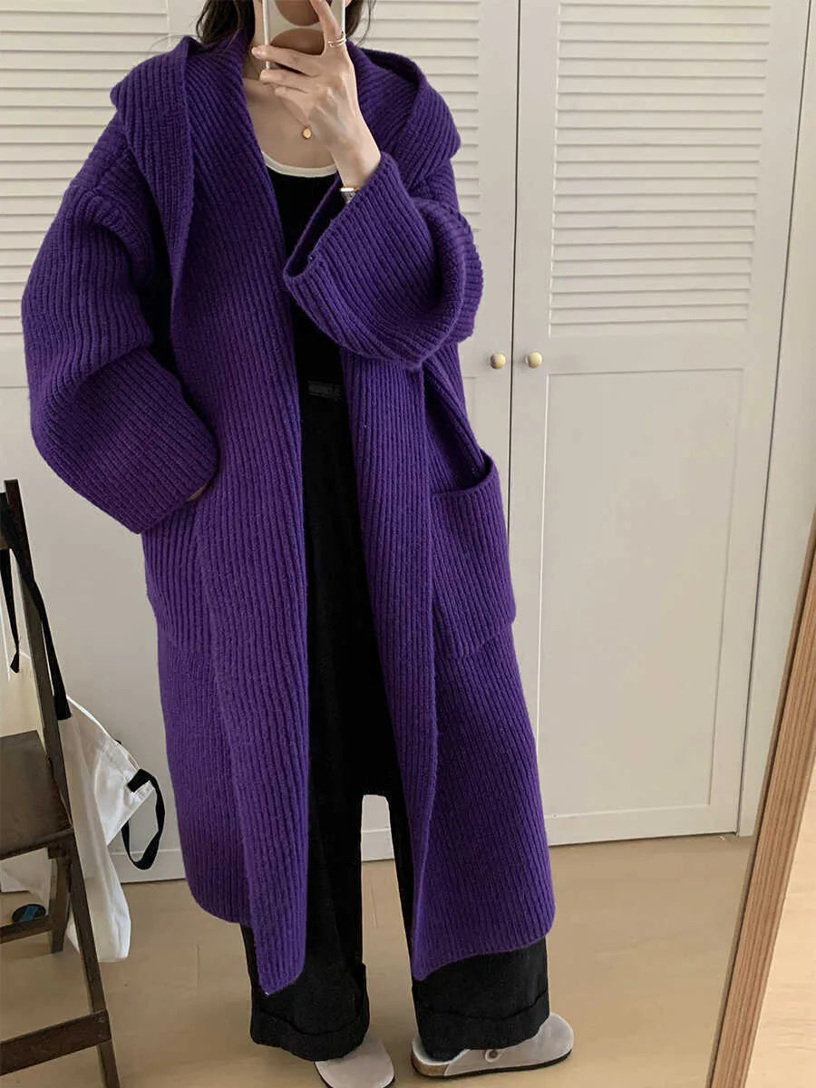 Women's loose grey hooded cardigan coat with raglan sleeves on a hanger