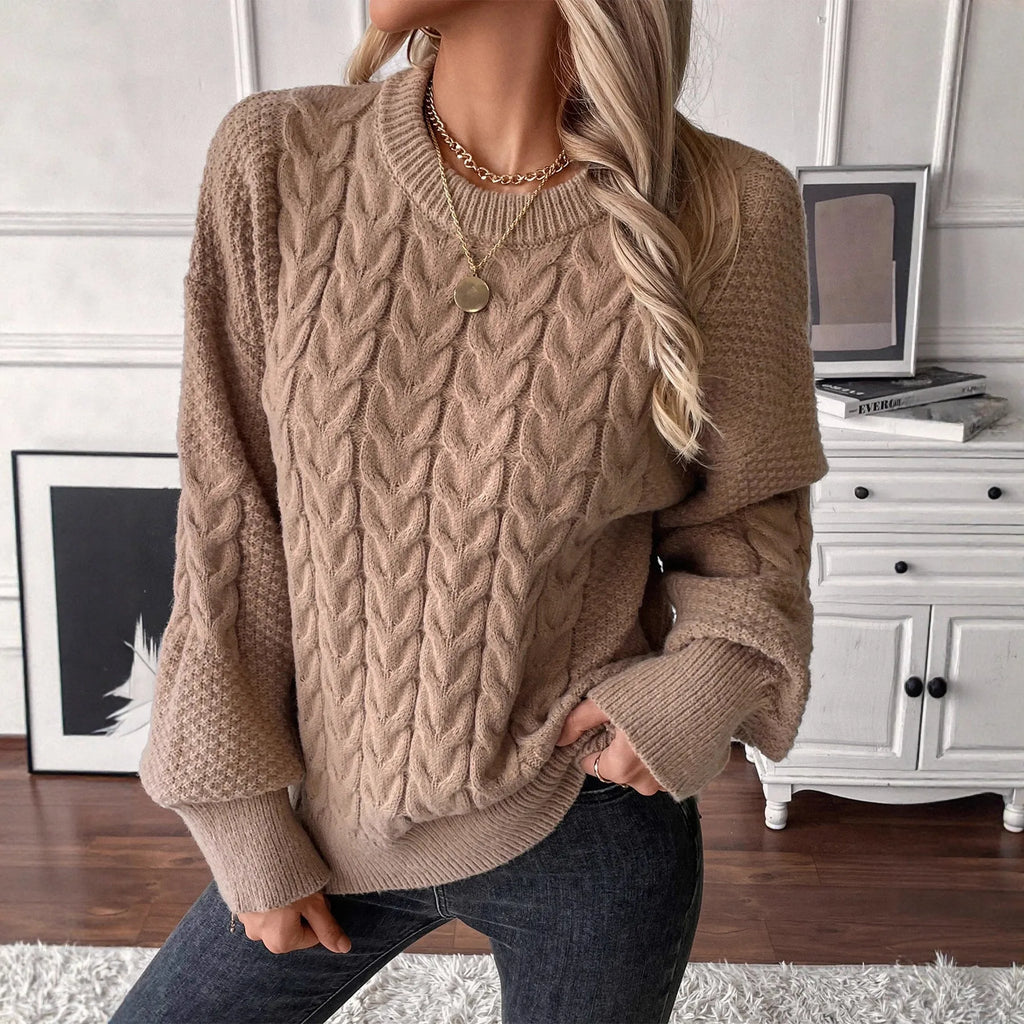 Beige women's loose casual sweater with round neck and a subtle twist design detail on the front
