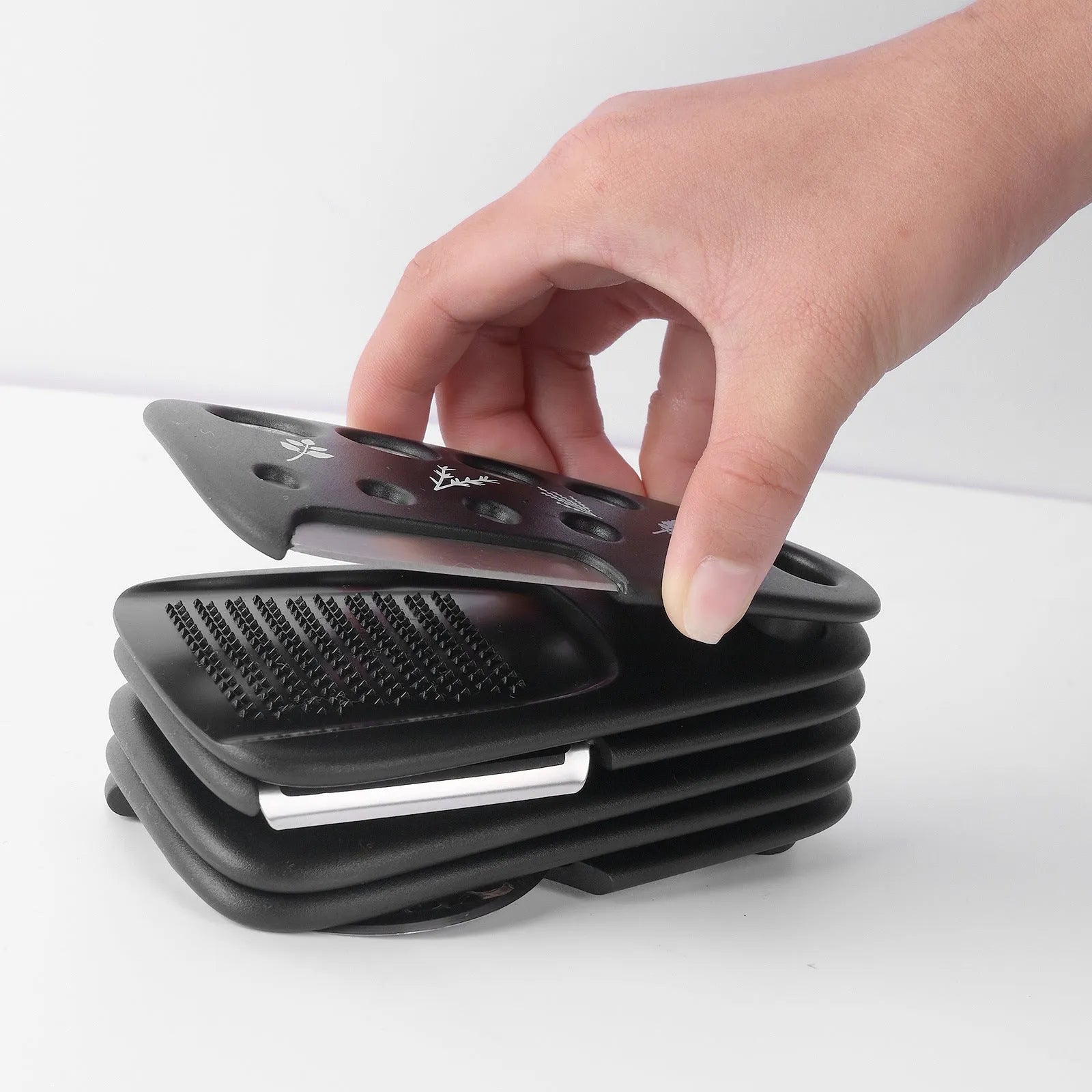 Six stainless steel kitchen gadgets stacked together in modern colour box with cleaning brush