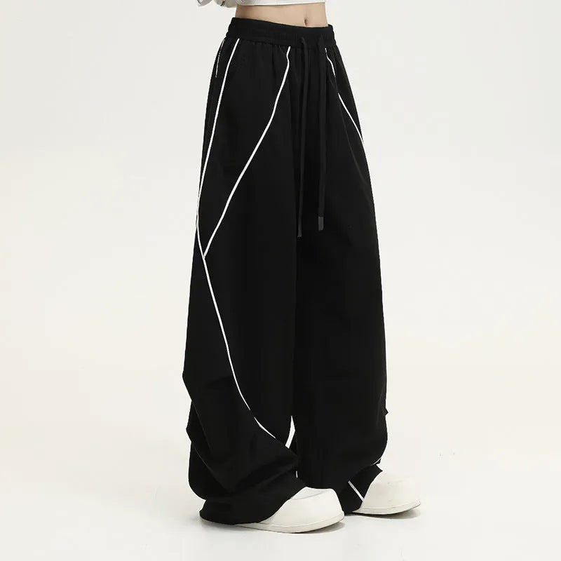 Black striped pleated hip hop wide-leg trousers with mid waist on mannequin