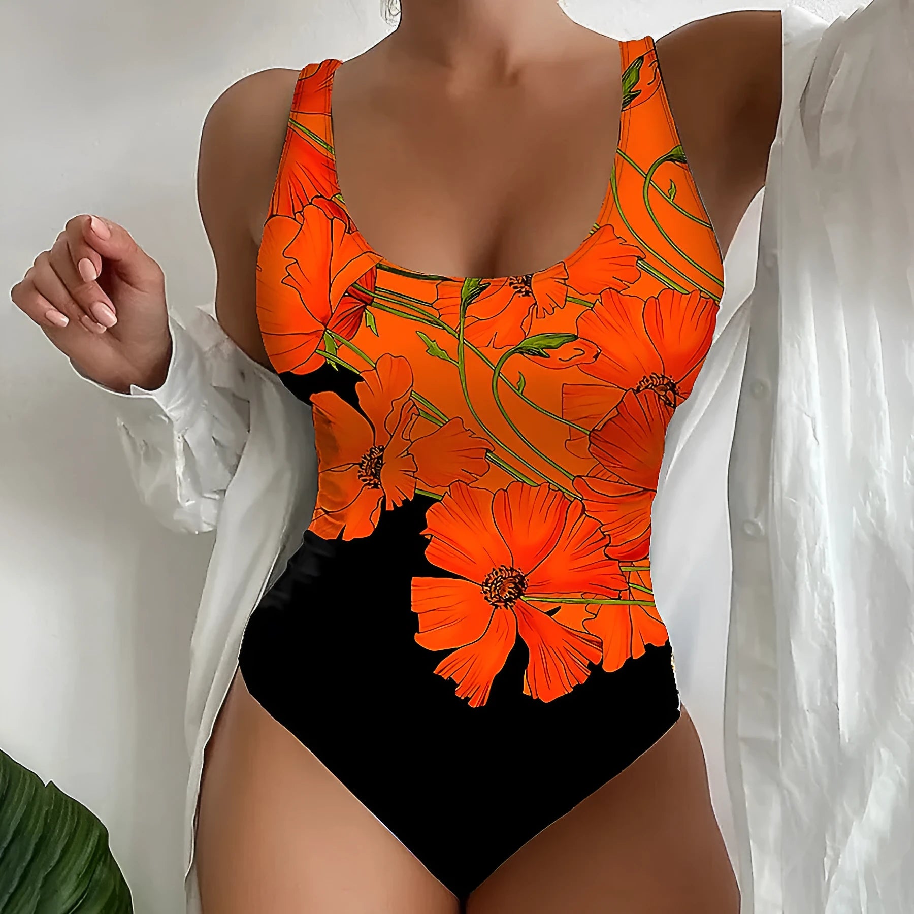 Orange flowers printed backless one-piece swimsuit laid flat, slim fit design.