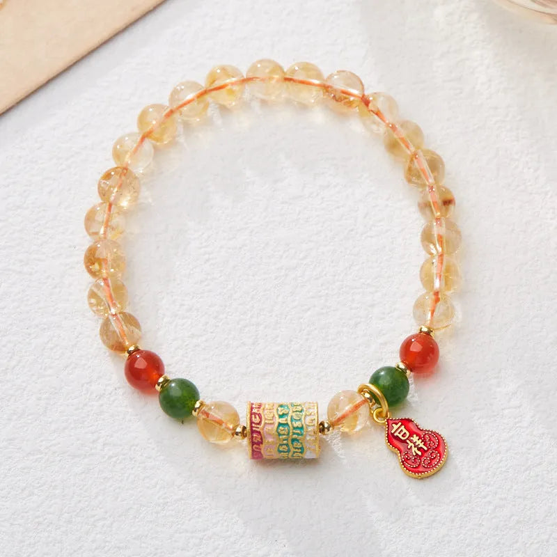 Hand-woven citrine crystal bracelet with five-sutra geometric pattern showing 6mm bead size