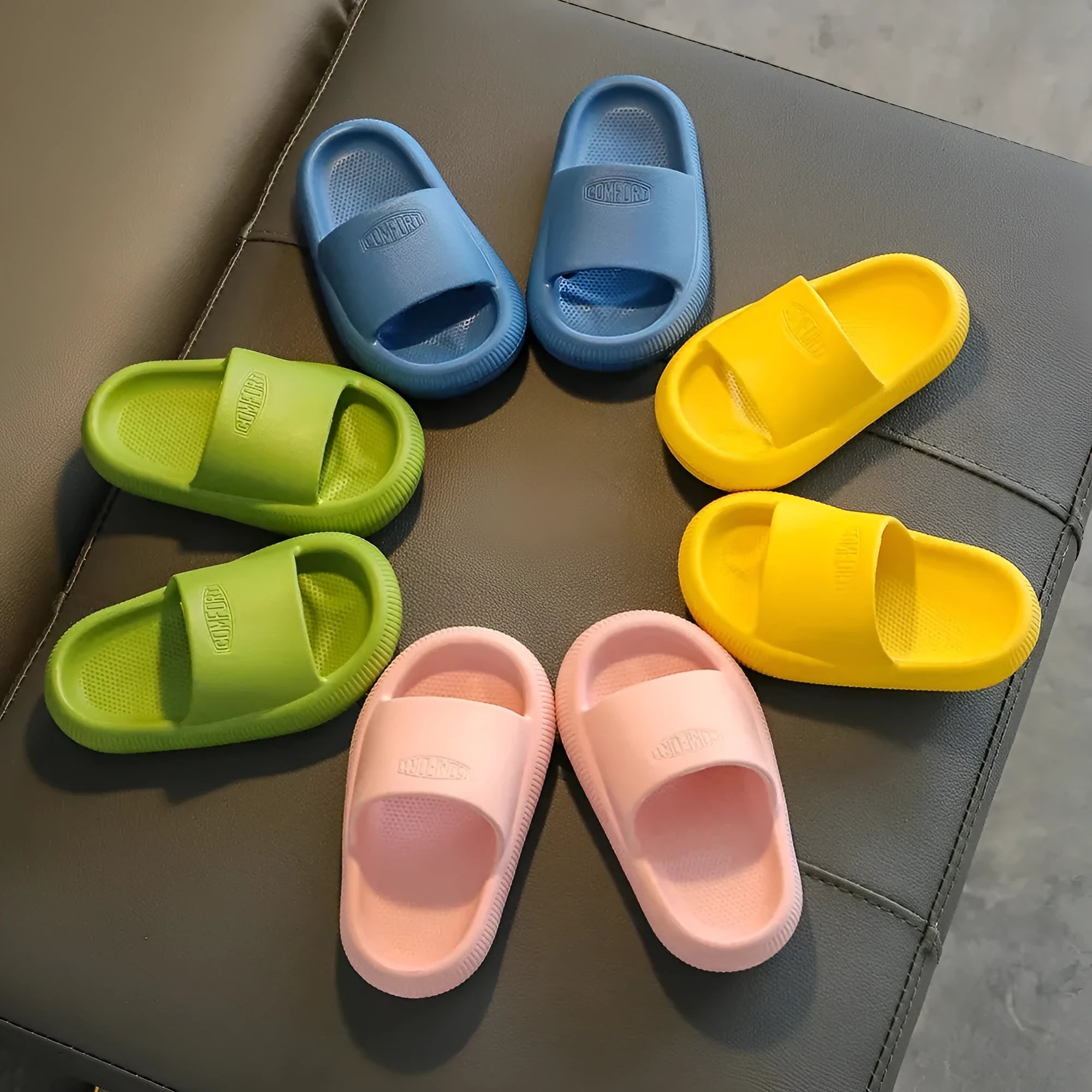 Mixed colour children's EVA slippers with non-slip soles in sizes for ages 24-35.