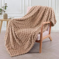 Children's soft plaid fleece blanket in camel colour showing texture and size.