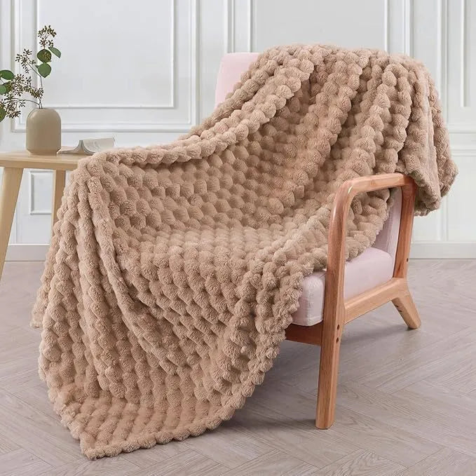 Children's soft plaid fleece blanket in camel colour showing texture and size.