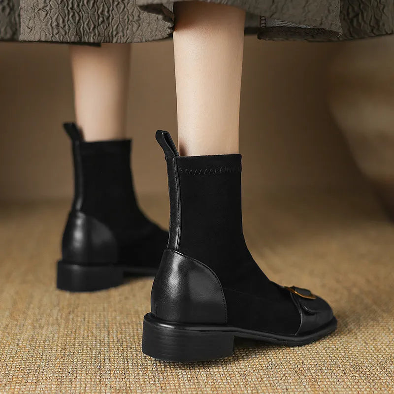 Black women's low heel martin boot with lace-up front and belt buckle stitching detail.