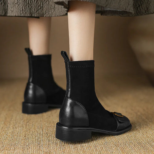 Black women's low heel martin boot with lace-up front and belt buckle stitching detail.