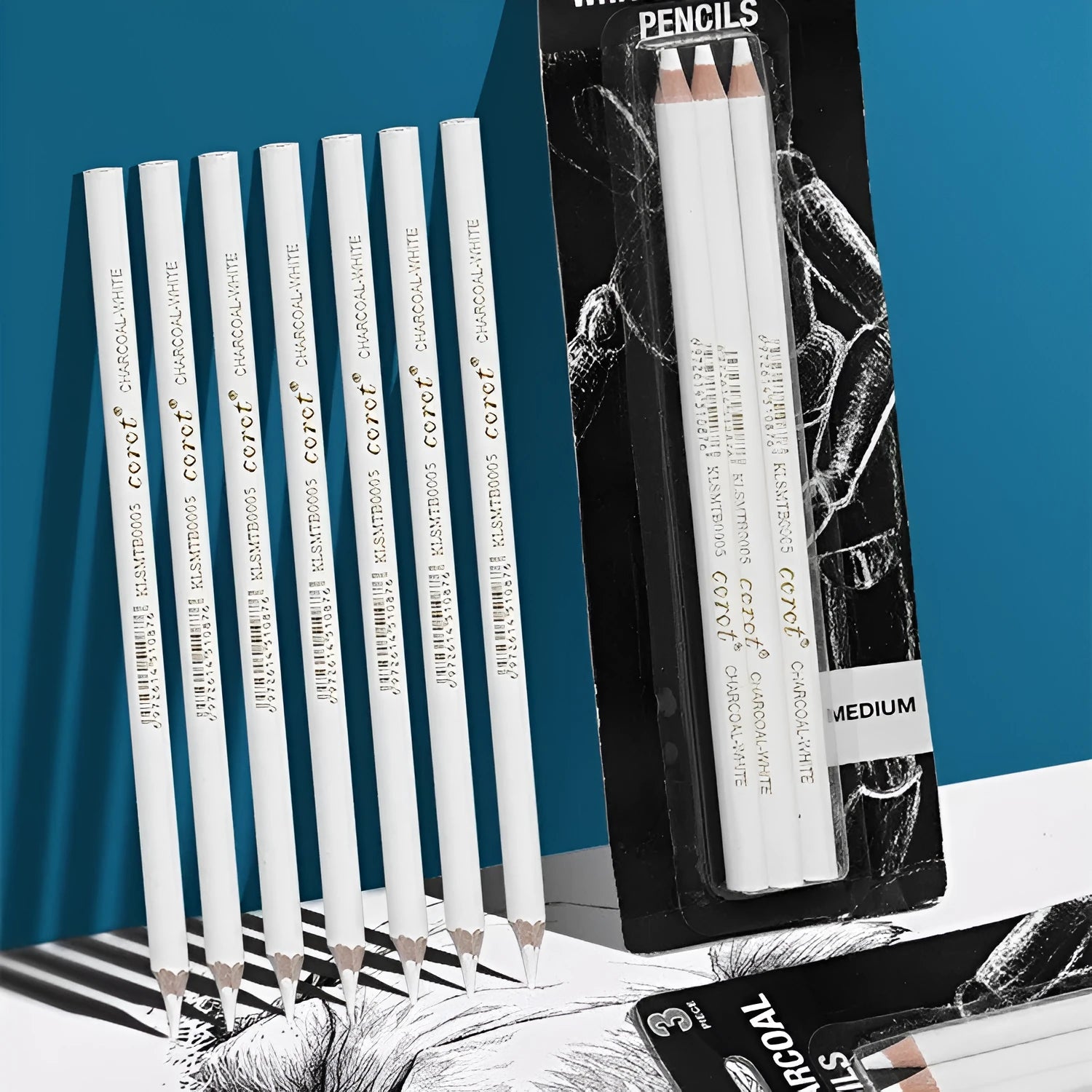 Three white charcoal sketching pencils with wooden barrels for highlighting artwork