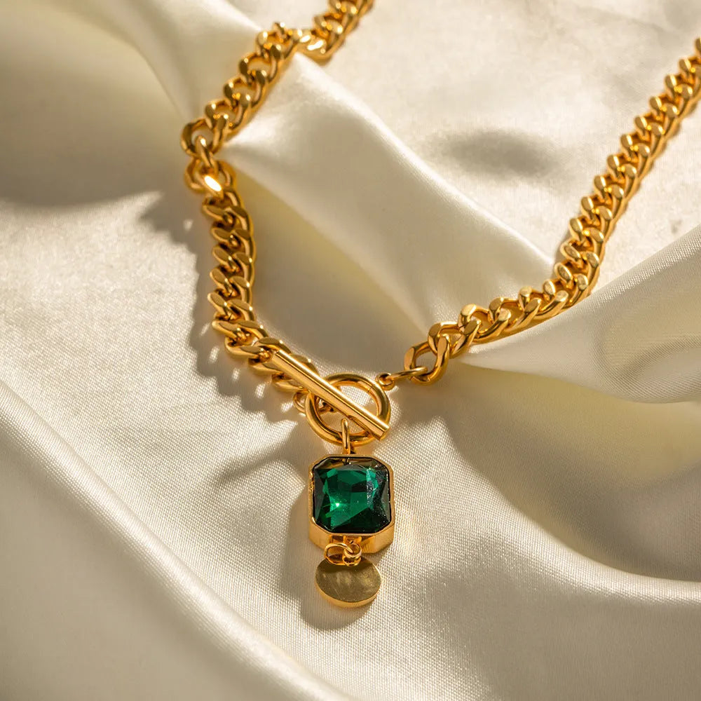 Gold electroplated titanium steel pendant necklace with geometric round design and Cuban link chain