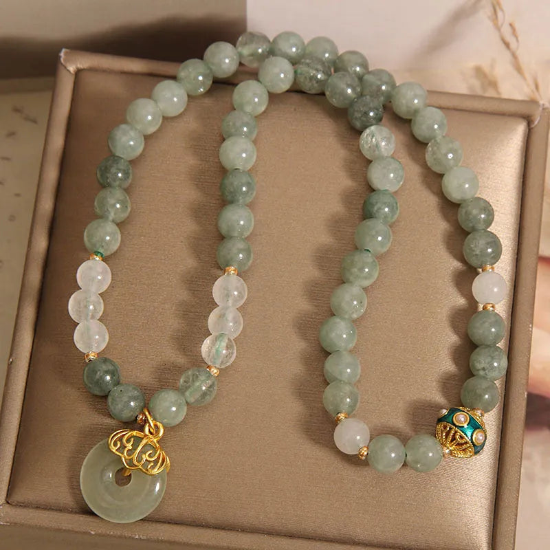 Women's double-layer aventurine jade bracelet with peace buckle closure in emerald green