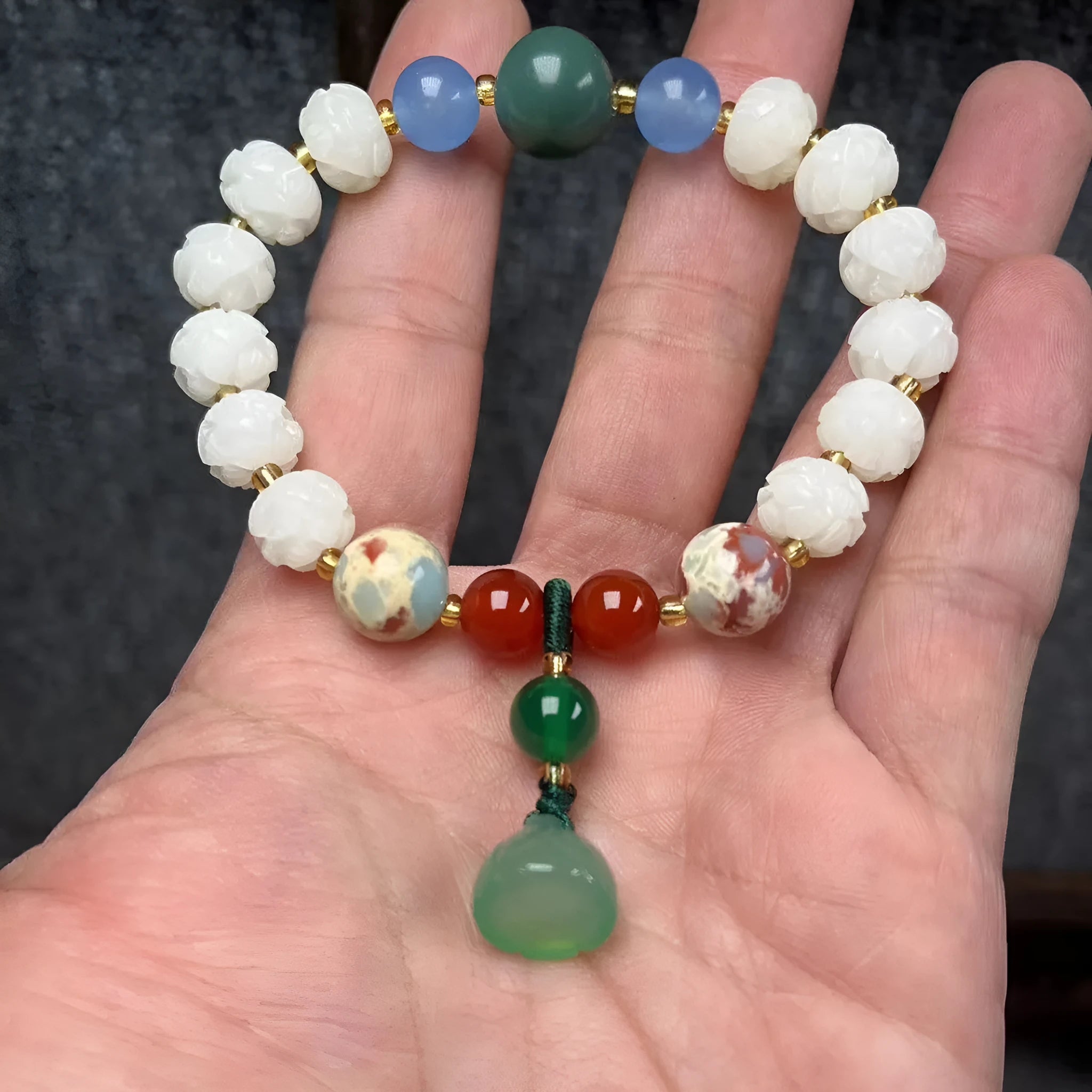 Carved pumpkin and lotus bead bracelet made from Bodhi root with white jade and aventurine details.