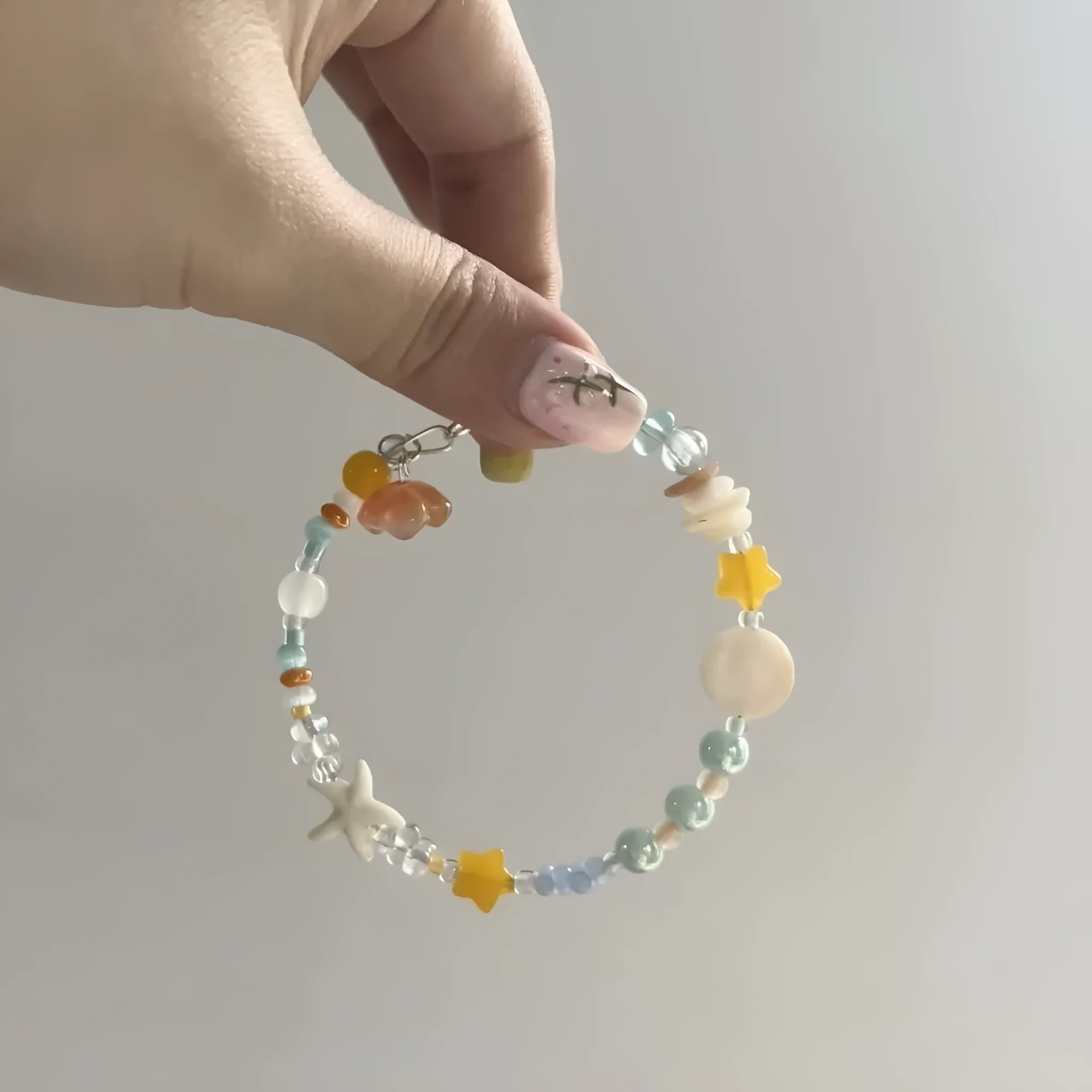 Orange sea colour diamond bracelet with round accents on adjustable alloy band