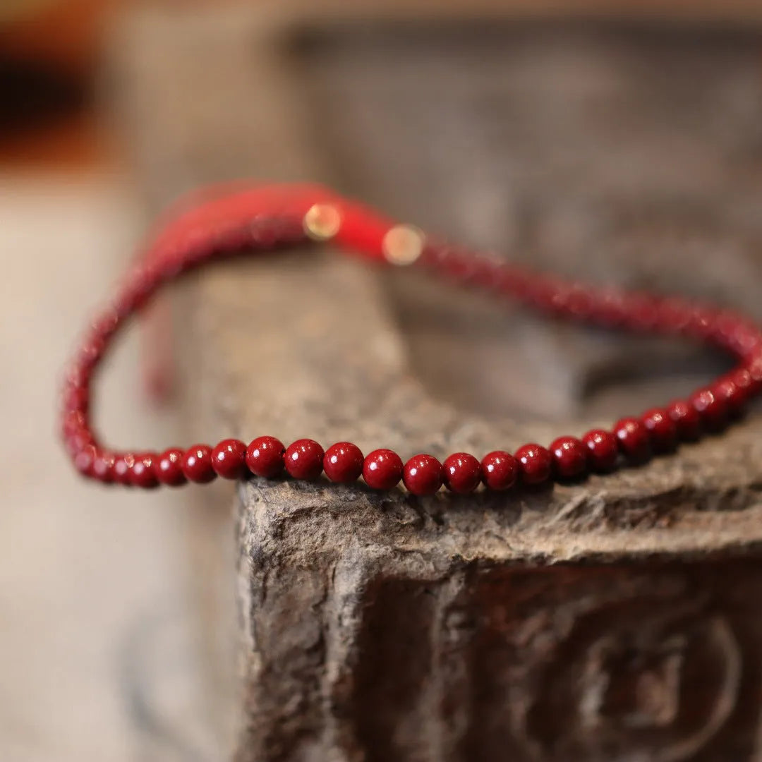 Close-up of a purple gold sand cinnabar bracelet with geometric shapes and auspicious patterns.