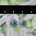 Handmade Miao silver ethnic earrings with turquoise stones in geometric flower disk design