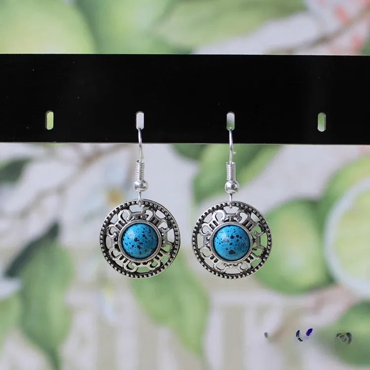Handmade Miao silver ethnic earrings with turquoise stones in geometric flower disk design