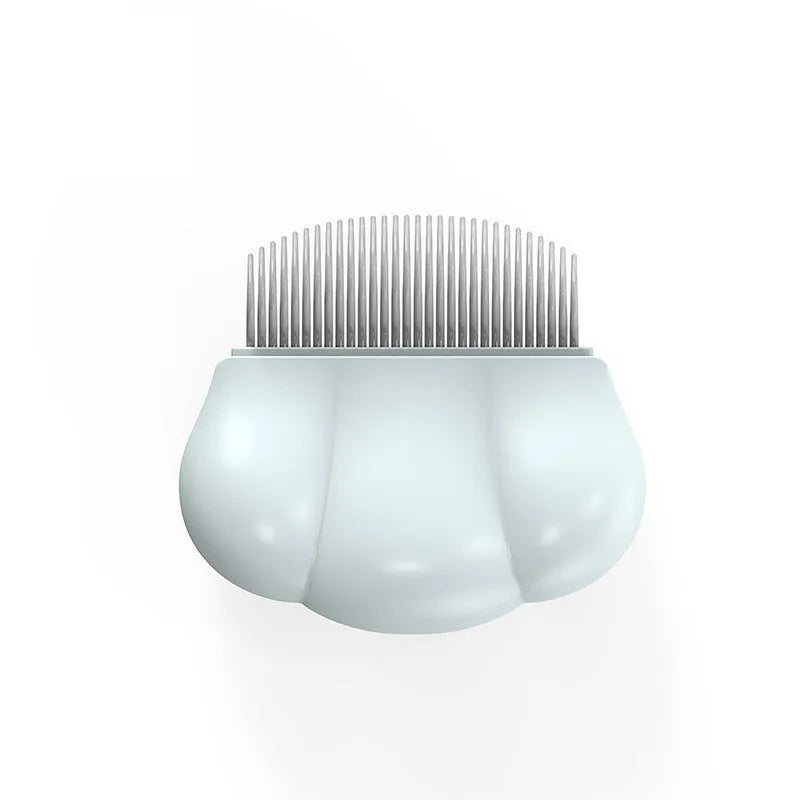 Paw Soft deshedding brush grooming tool for cats and dogs on a white surface.