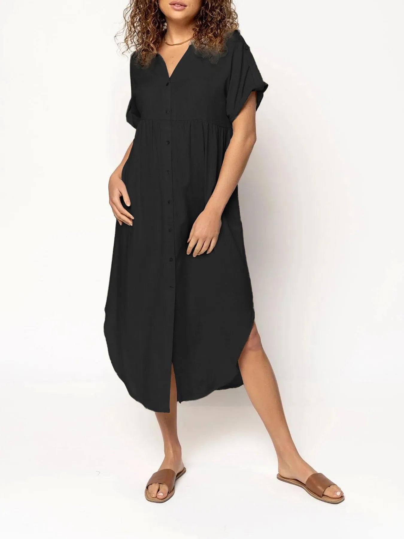 A loose-fitting, mid-length casual dress with button detail on the front, shown in a solid colour.