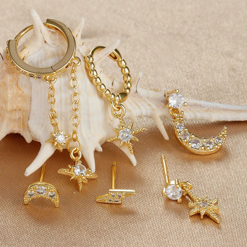Set of six gold-coloured XINGX women's earrings with zircon studs and chain tassels.