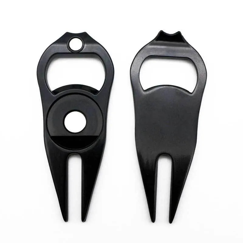 Black zinc alloy golf ball yoke fork with integrated bottle opener tool on green turf.