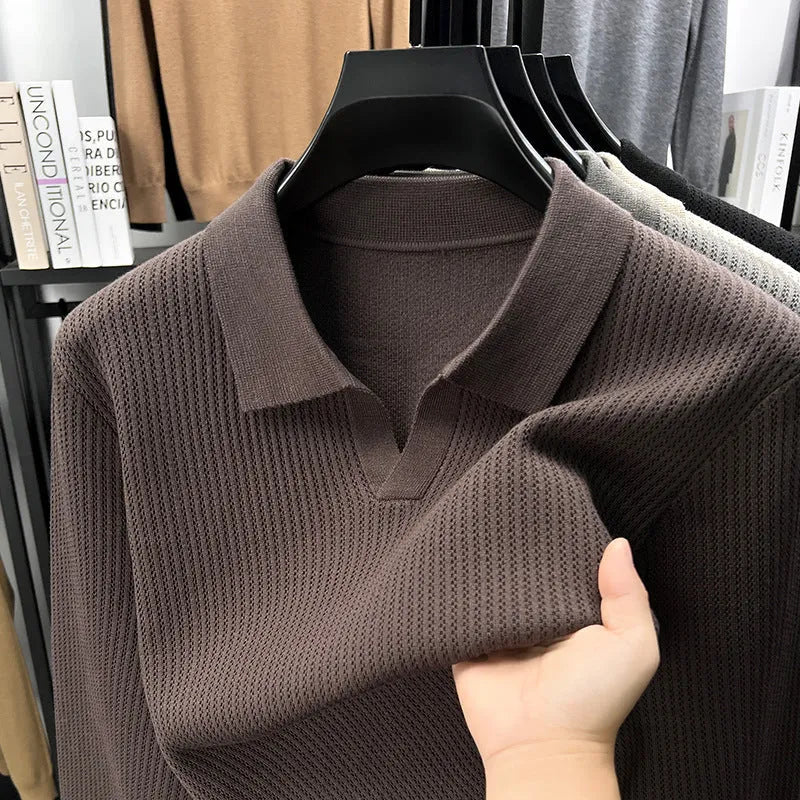 A man's loose-fitting casual pullover jumper in a neutral colour, shown on a model.