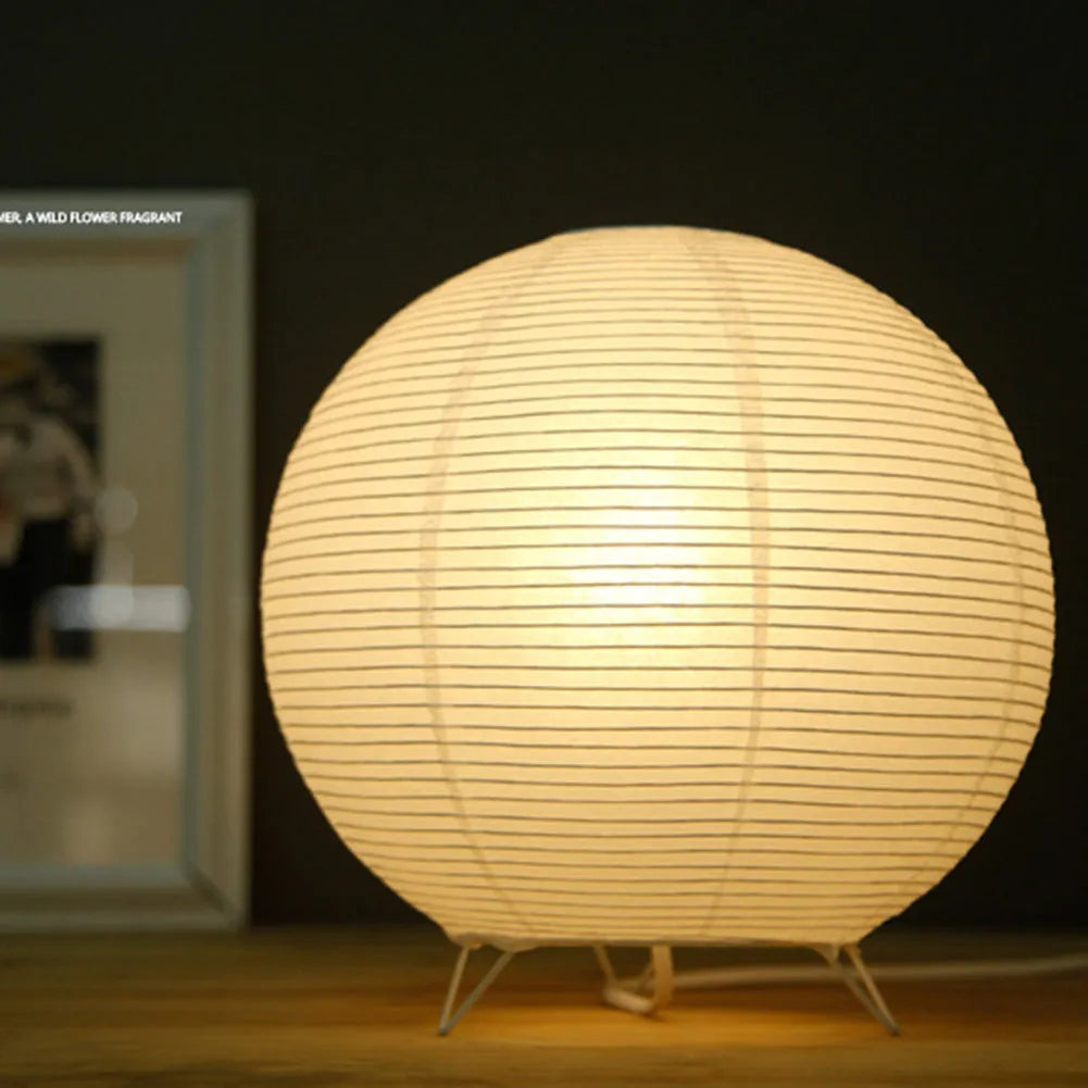 Small white table lamp with rice paper shade on bedside table, circular shape, traditional handwork