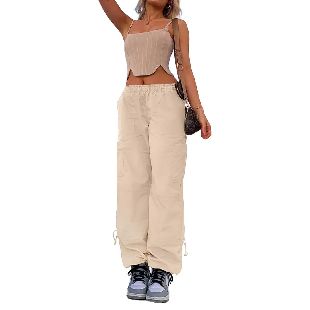 Man wearing loose grey straight-leg cargo casual pants with multiple pockets.