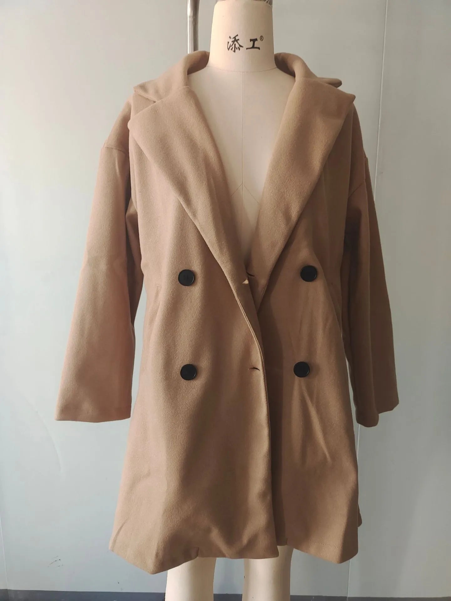 Women's mid-length coat with fur collar, button front, and side pockets in black