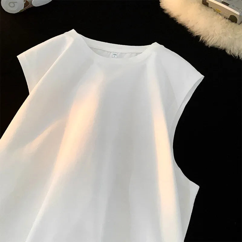 Men's loose solid colour sleeveless cotton tank top on a hanger, shown in a light apricot shade.