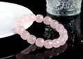Pink crystal barrel bead bracelet with 11mm to 12mm geometric beads on natural background