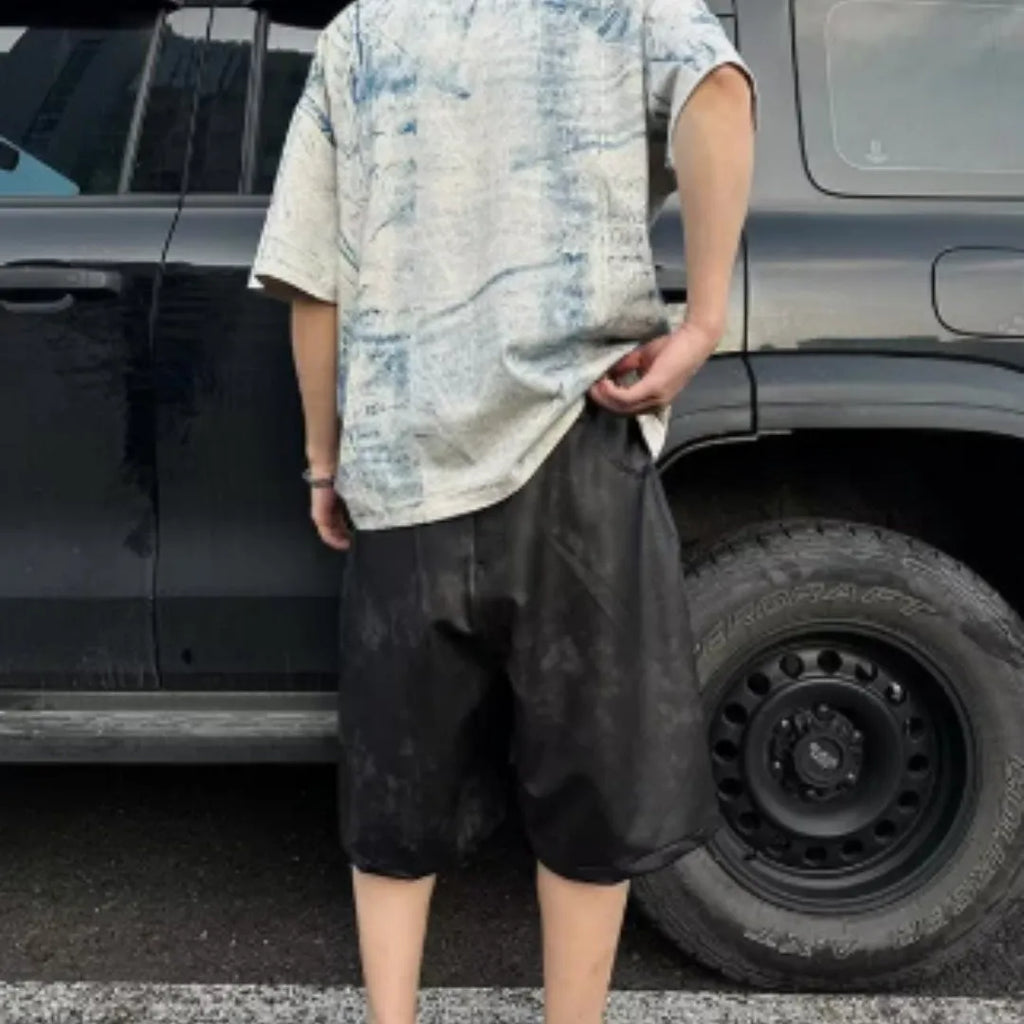 Korean style loose fit T-shirt with a full printed tie dye design on a solid colour background.