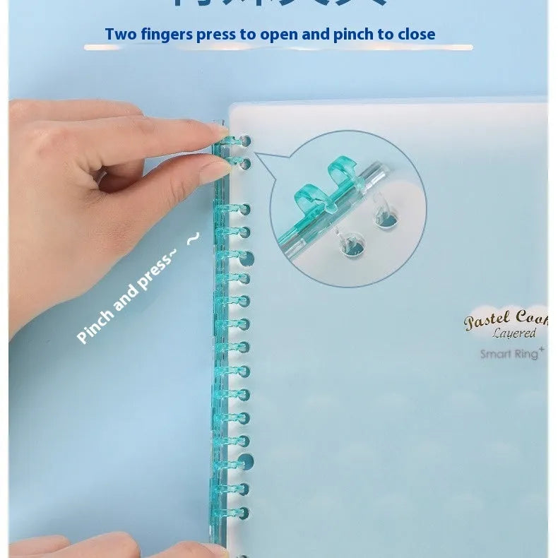 Loose-leaf spiral notebook with PP cover open, showing raw wood pulp pages in A5 or B5 size.