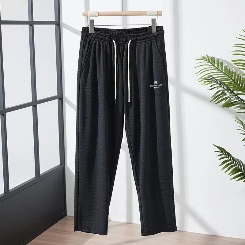 Men's ice silk thin breathable quick-drying casual pants in black, loose straight-leg style with drawstring waist