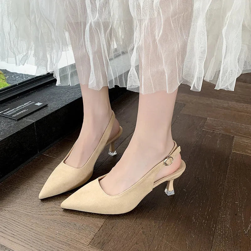 Apricot suede stiletto high heels with a pointed toe and rubber sole on a plain background.