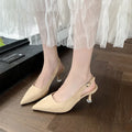 Apricot suede stiletto high heels with a pointed toe and rubber sole on a plain background.