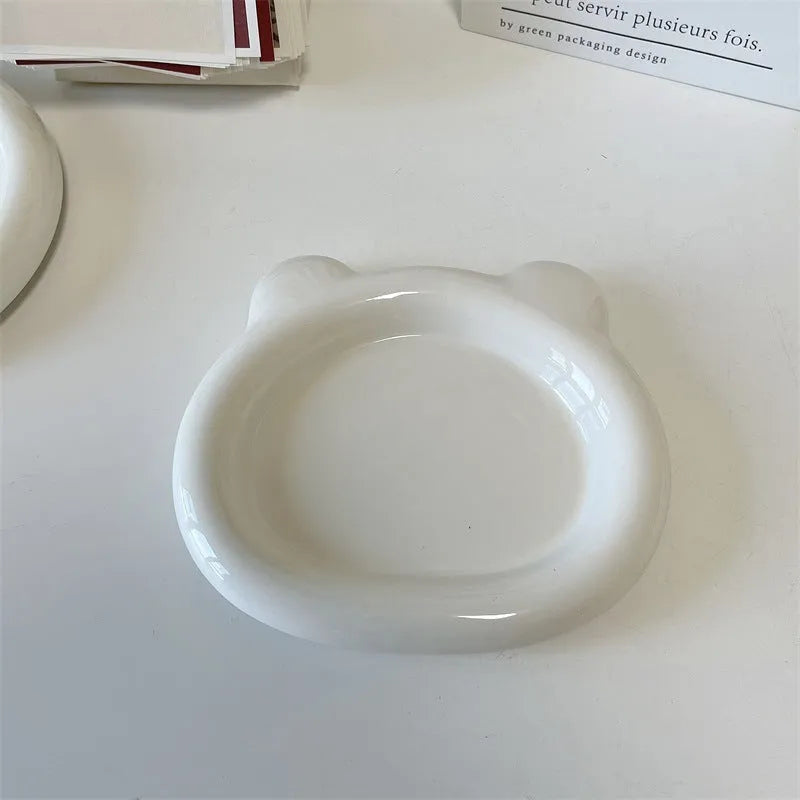 White ceramic plate with doodle design showing bear pattern, suitable for microwave use