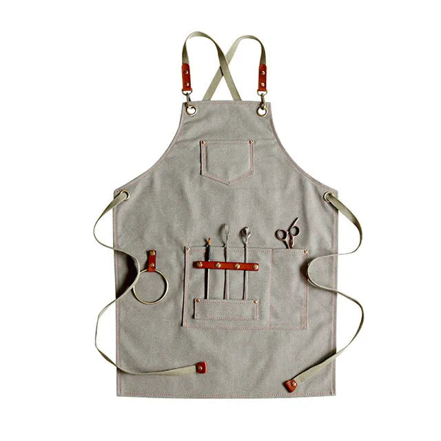 Canvas cross strap apron in camel colour shown from the front.