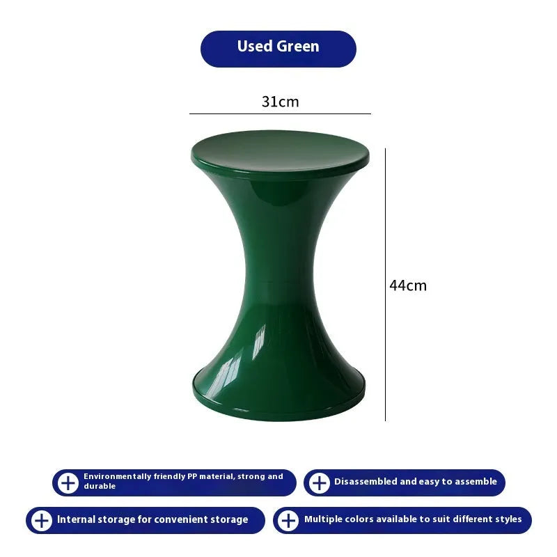 Plastic hourglass-shaped shoe changing stool in selected colour, shown in a home entryway setting.