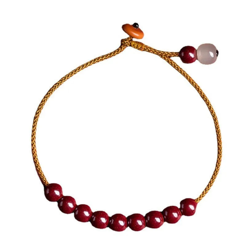 Hand-woven bracelet made from raw cinnabar ore and Hetian jade in a simple geometric shape.