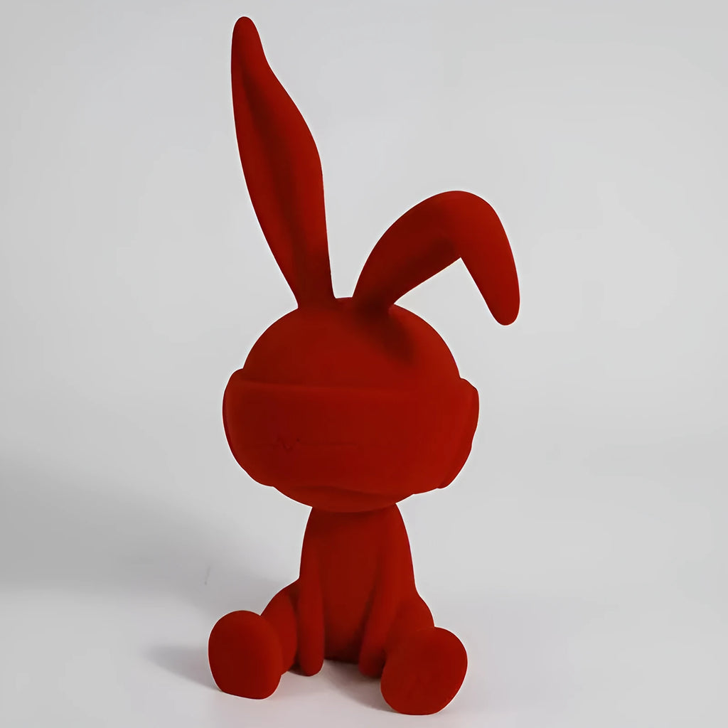 Suede blindfold rabbit resin table ornament in chosen colour on a wooden surface.
