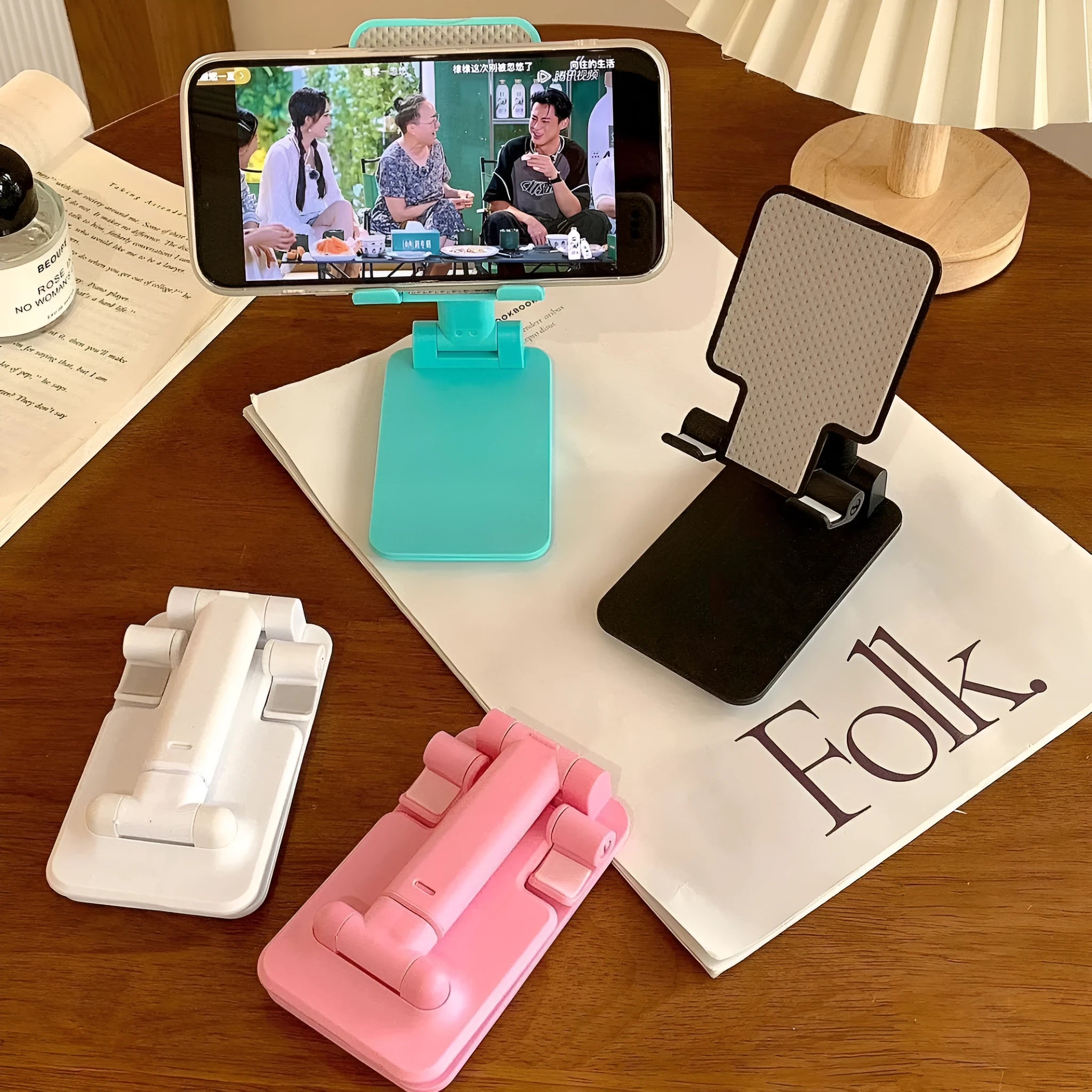 Folding plastic mobile phone stand in pearl white on a flat surface