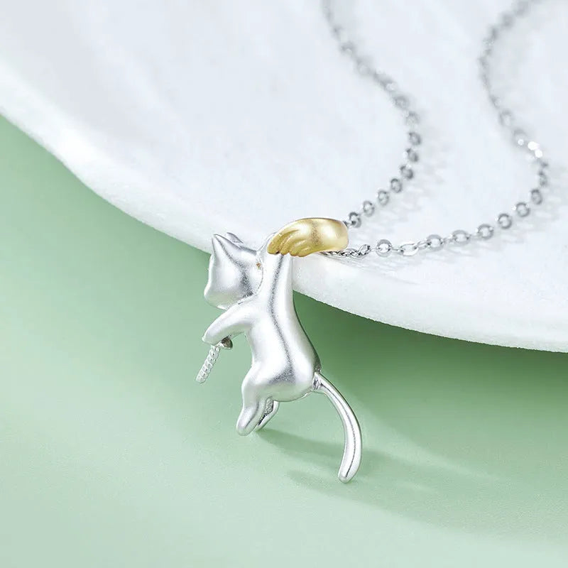 Close-up of a sterling silver cat charm clavicle chain necklace on a model.