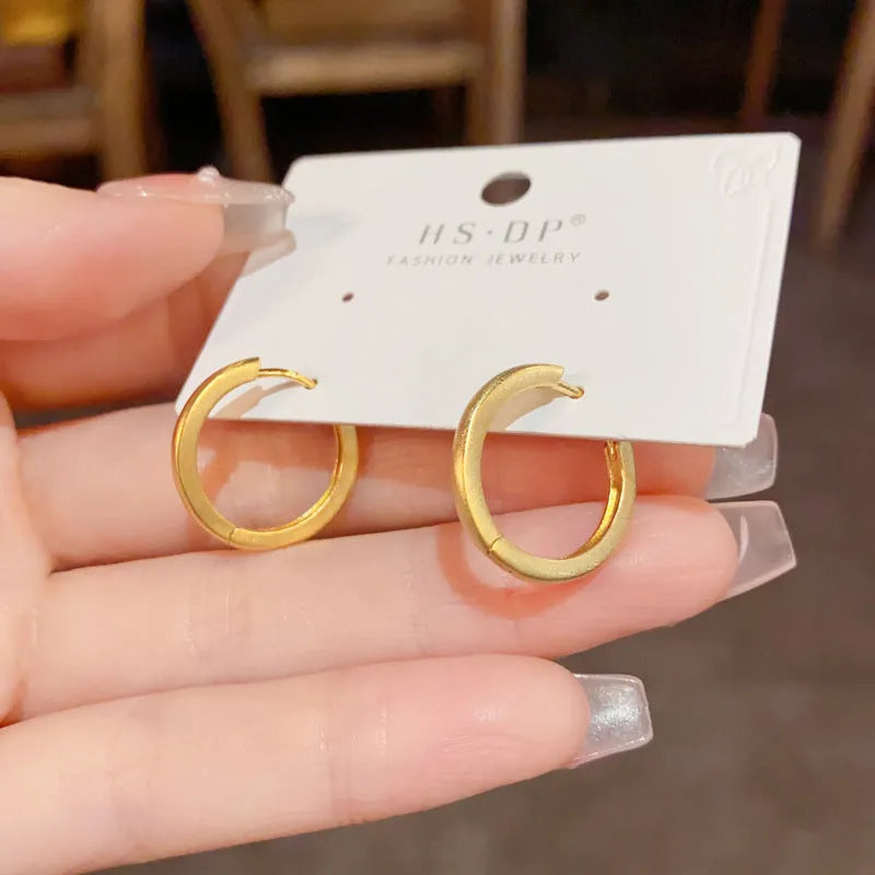Women's geometric ear clip with round design in gold and silver plated finishes