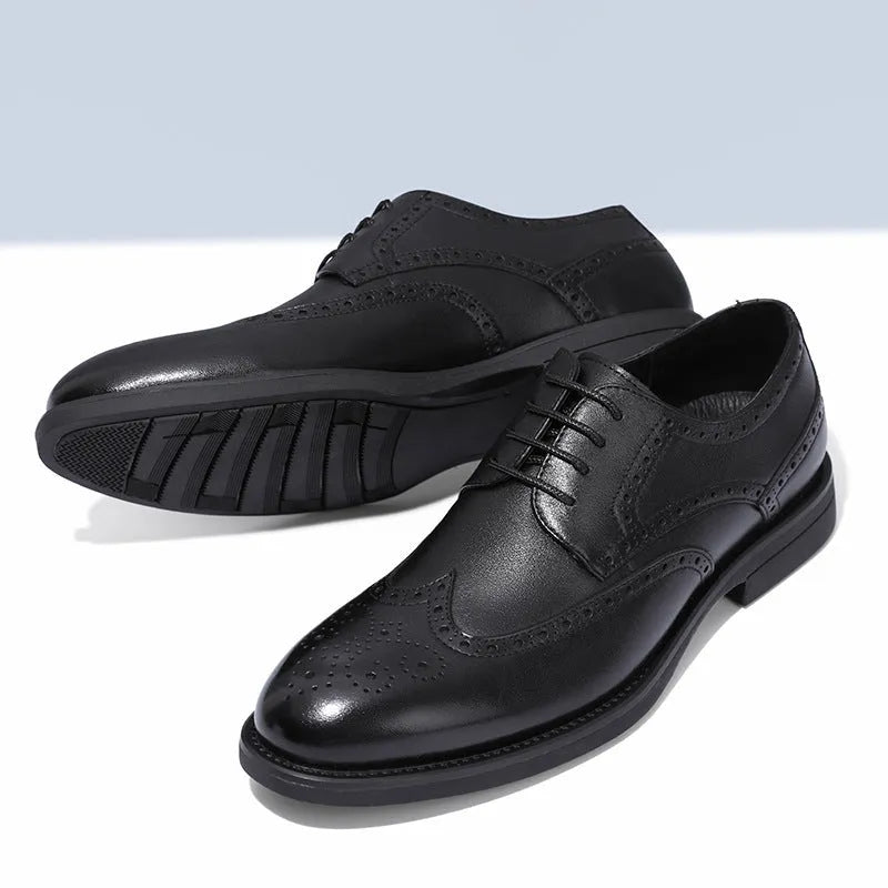 Men's black brogue leather shoes in a business style on a white background.