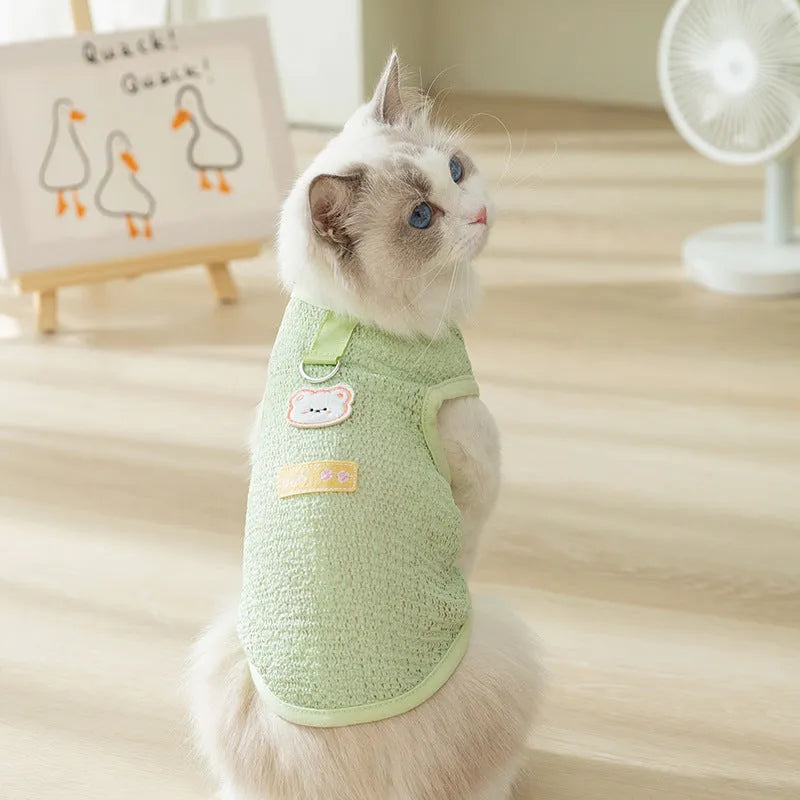 Green knitted cat top with hollowed-out design and a bear cartoon patch on the side