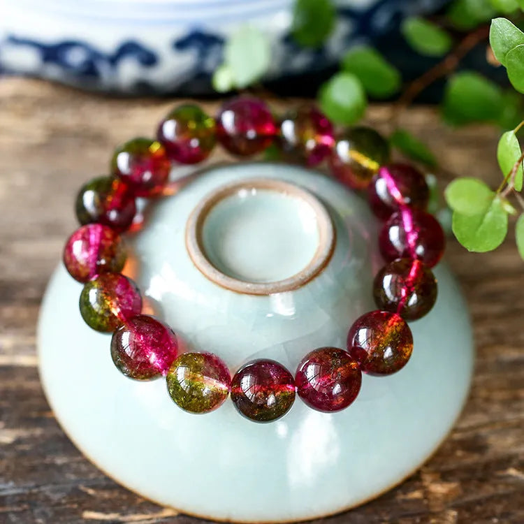 Handmade watermelon crystal bead bracelet with pastoral design elements on wrist