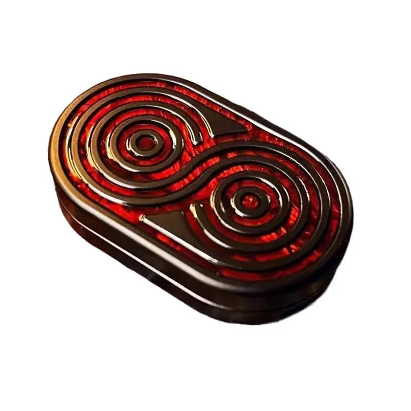 Stainless steel EDC hand push coin in agate red colour on plain background