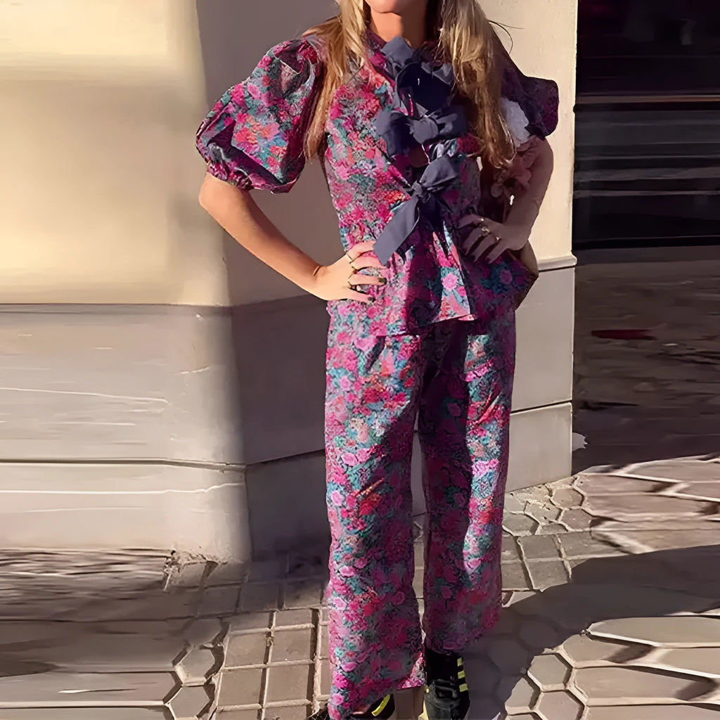 Floral print trousers suit with tie-neck blouse featuring puff sleeves and matching trousers